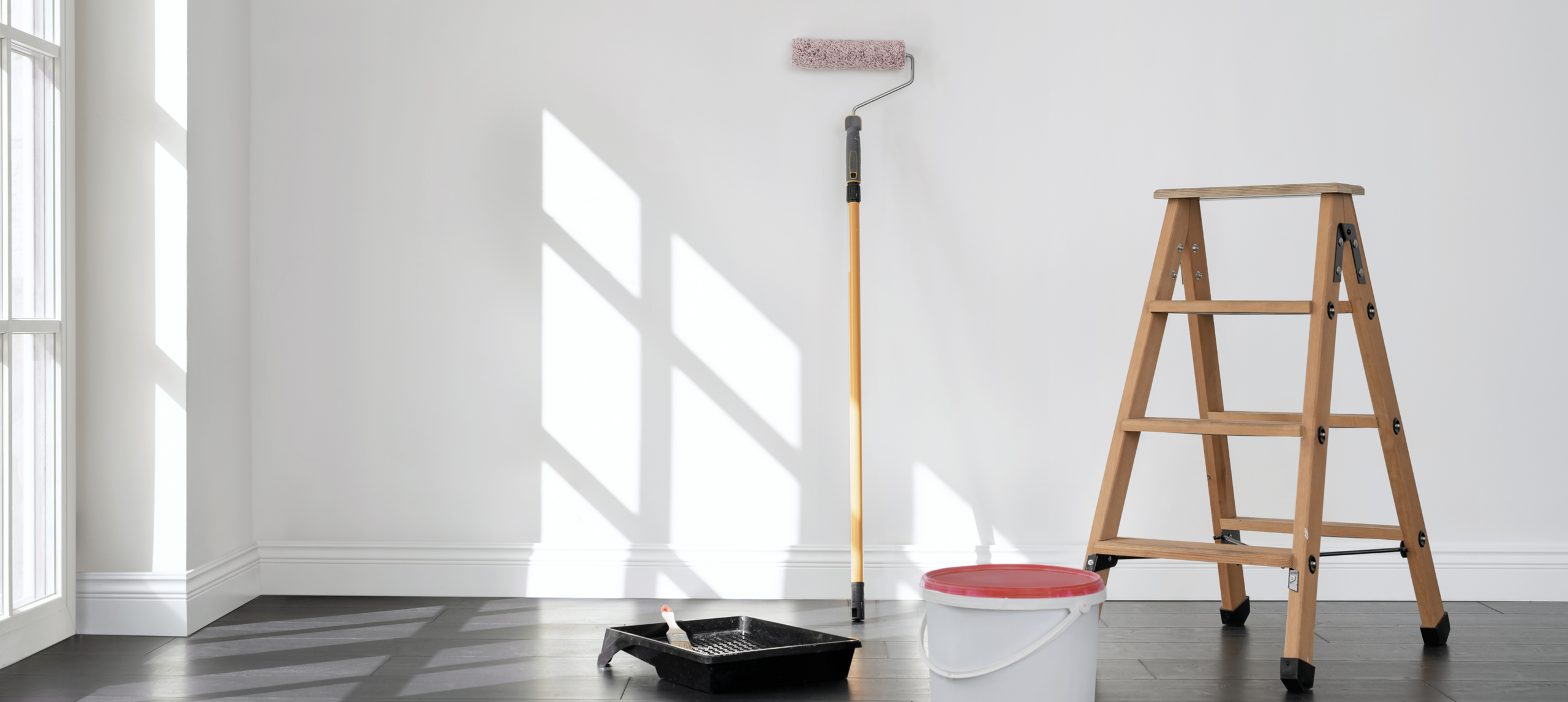 Ladder and paint tools by wall